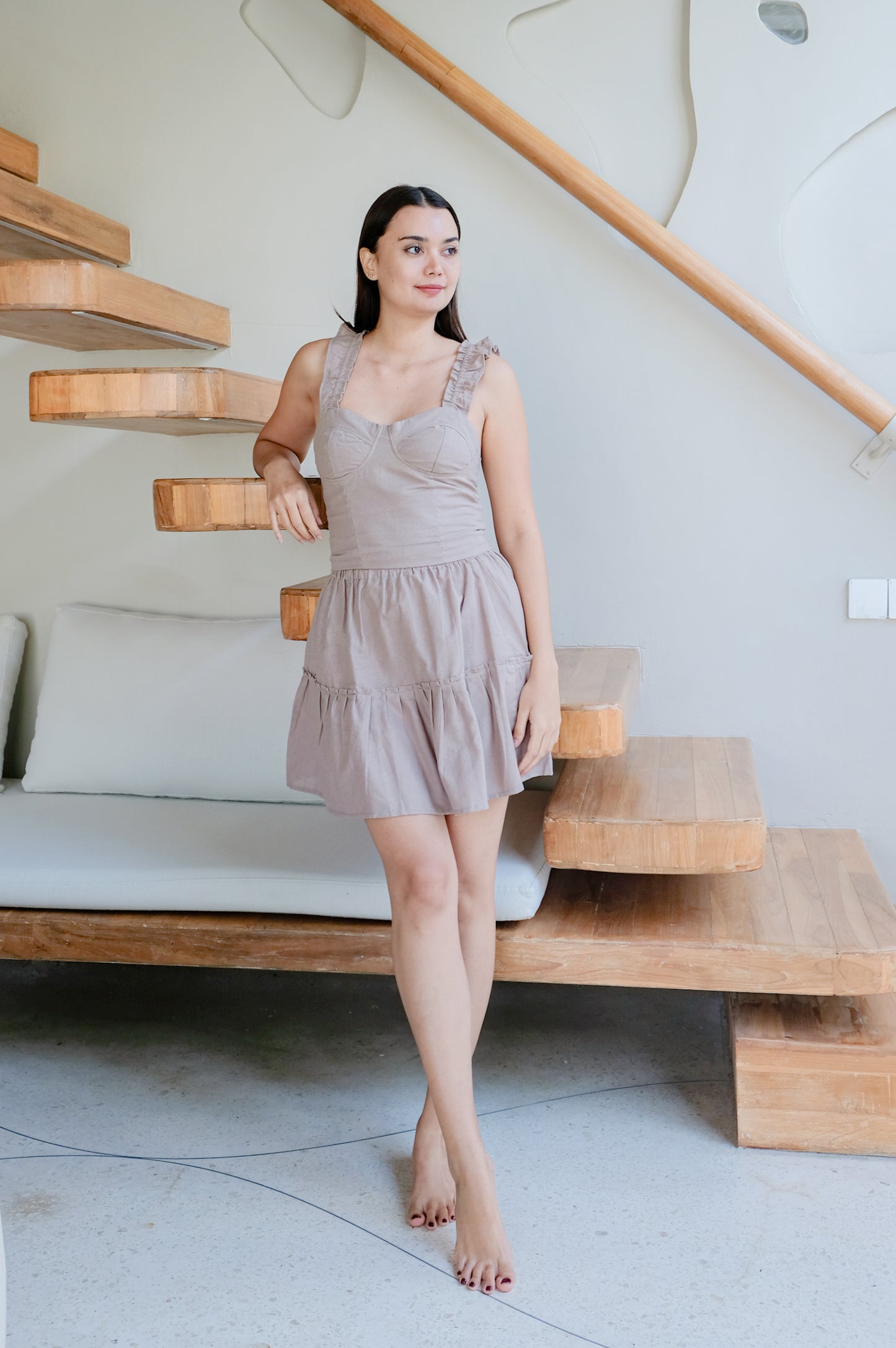 Elegant summer linen clothes in beige colour used by a standing model.
