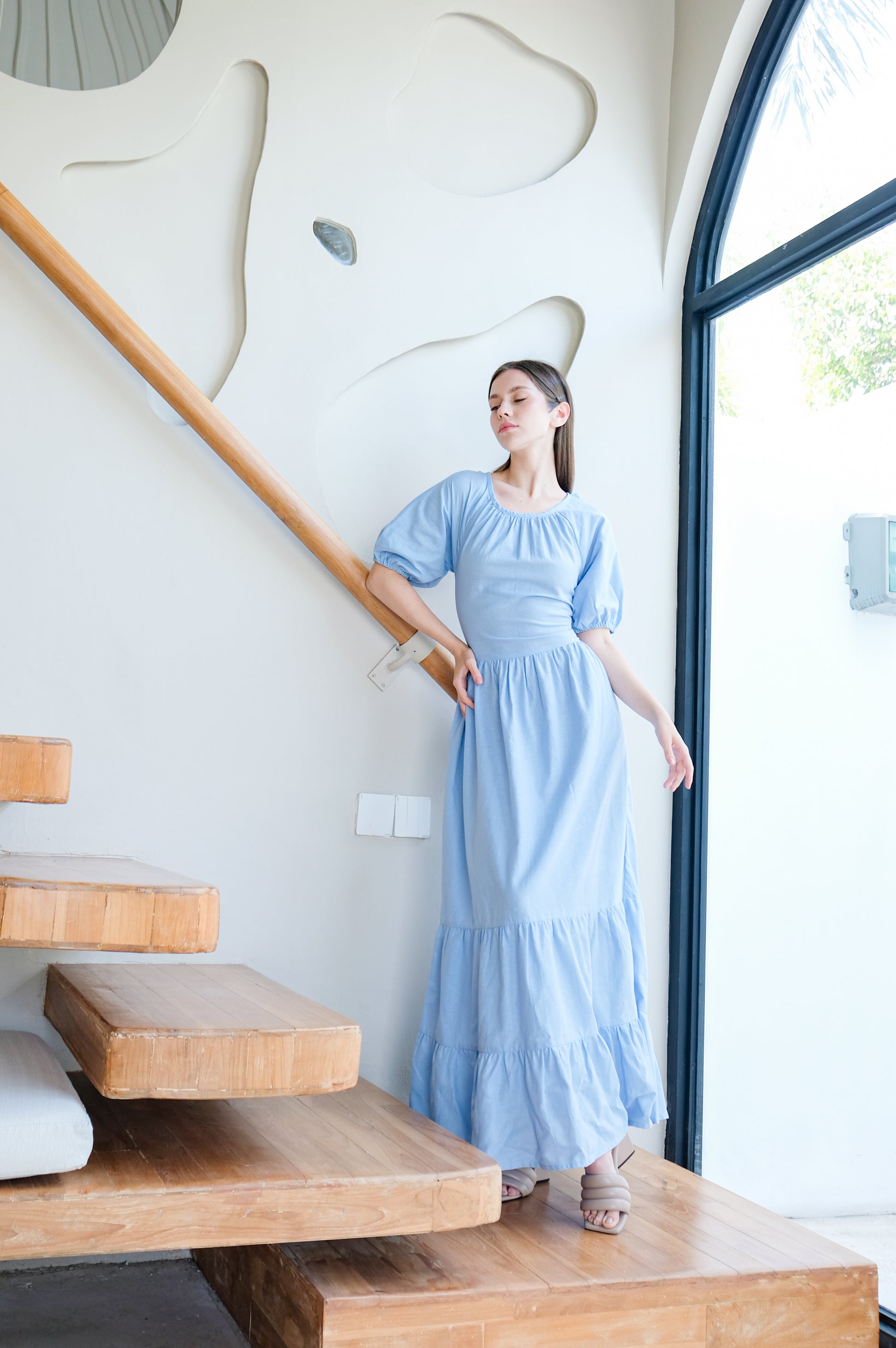 Calm posed model wearing modest elegant long linen dress by Una Linen Havn.