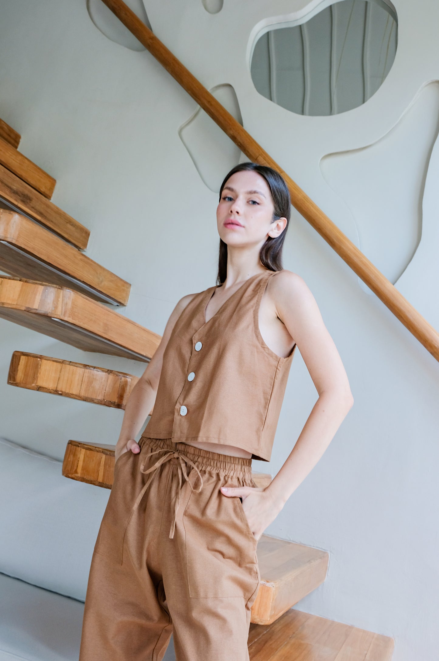 Brown linen set of top and trousers give a model confidence while photo shooting for Una Linen Havn.