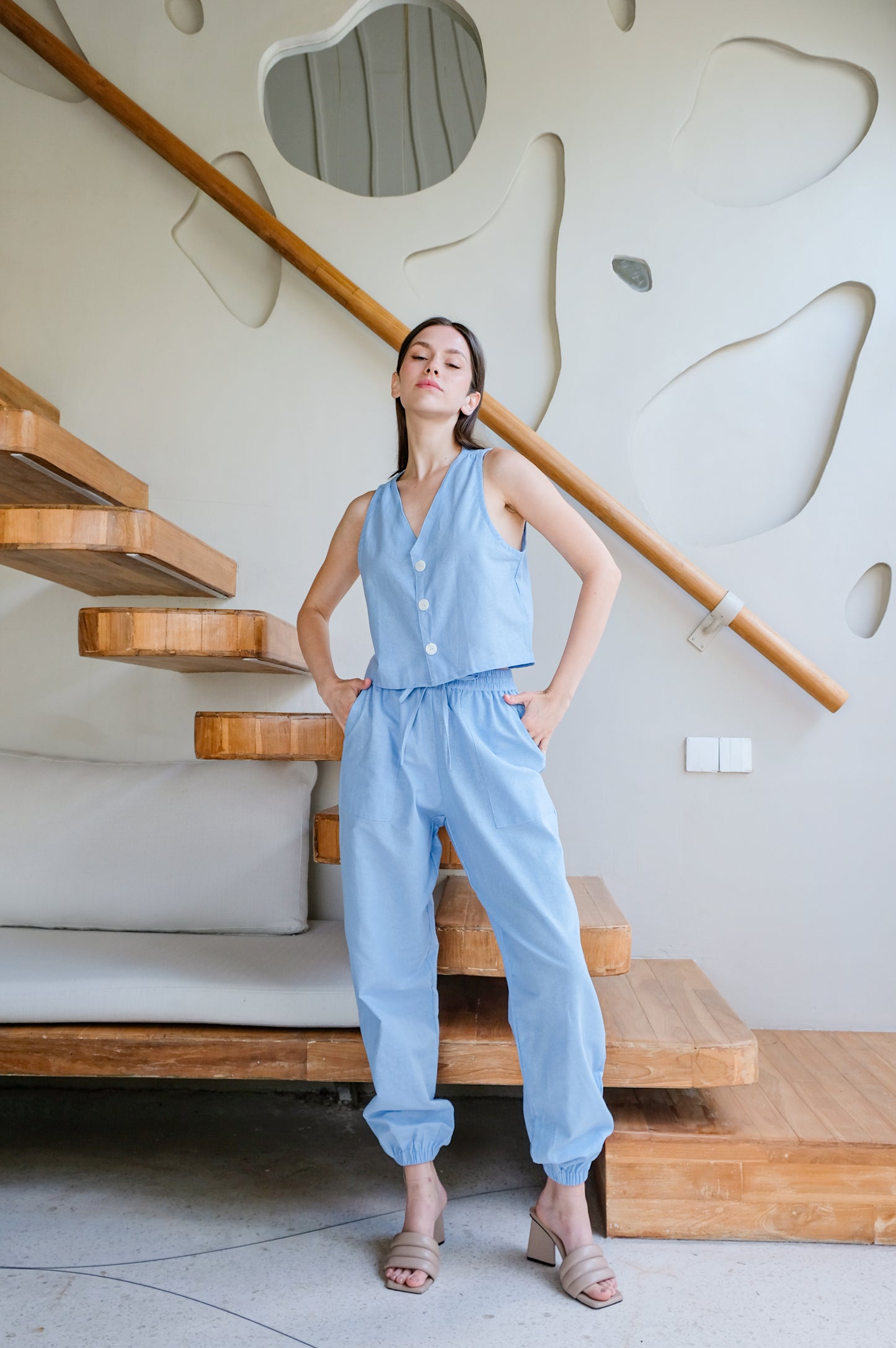 Model posing in light blue set of linen clothes inspired by Sevilla.