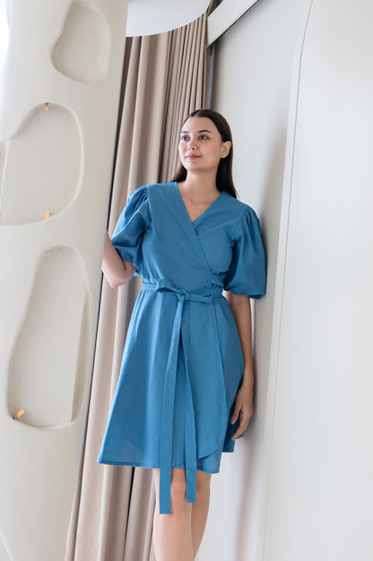 Blue kimono dress Kvilda made of linen wear by model in minimalistic interior.