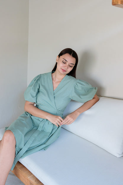 Green linen kimono dress on a sitting model.