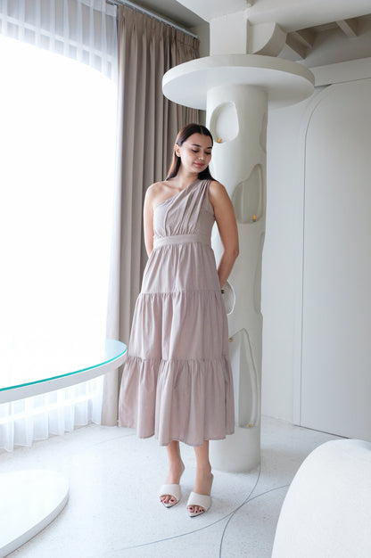 Display of beige linen dress with wide skirt on a model. 